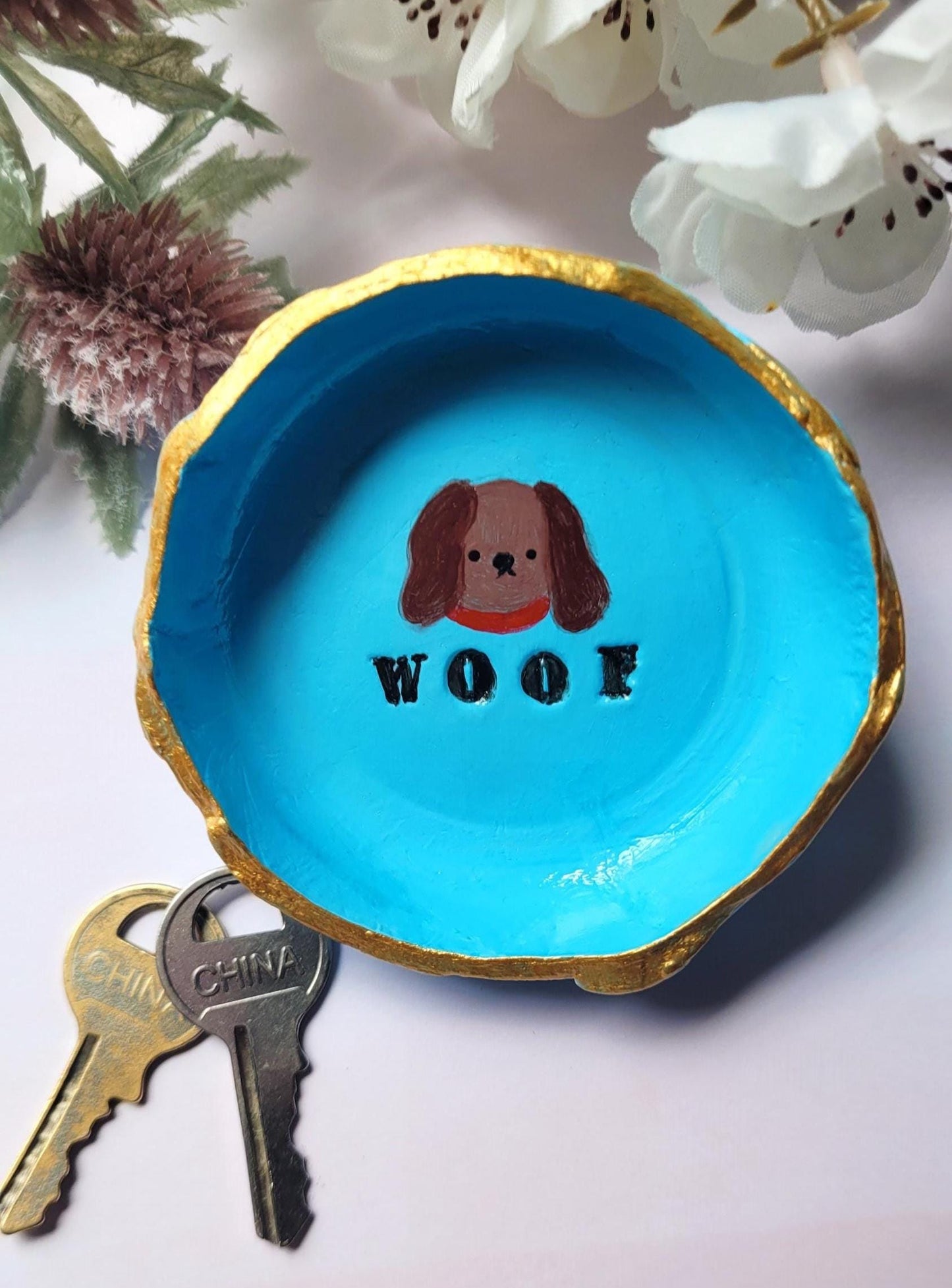 Blue Dog Trinket dish with Woof text on it.