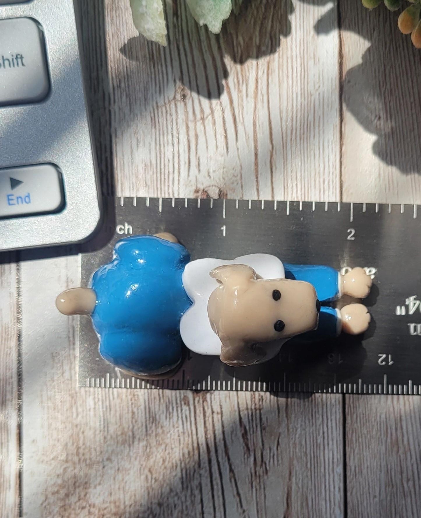 The dog miniature measures 2 inches x 1 inch or 5.08cm x 2.54cm.