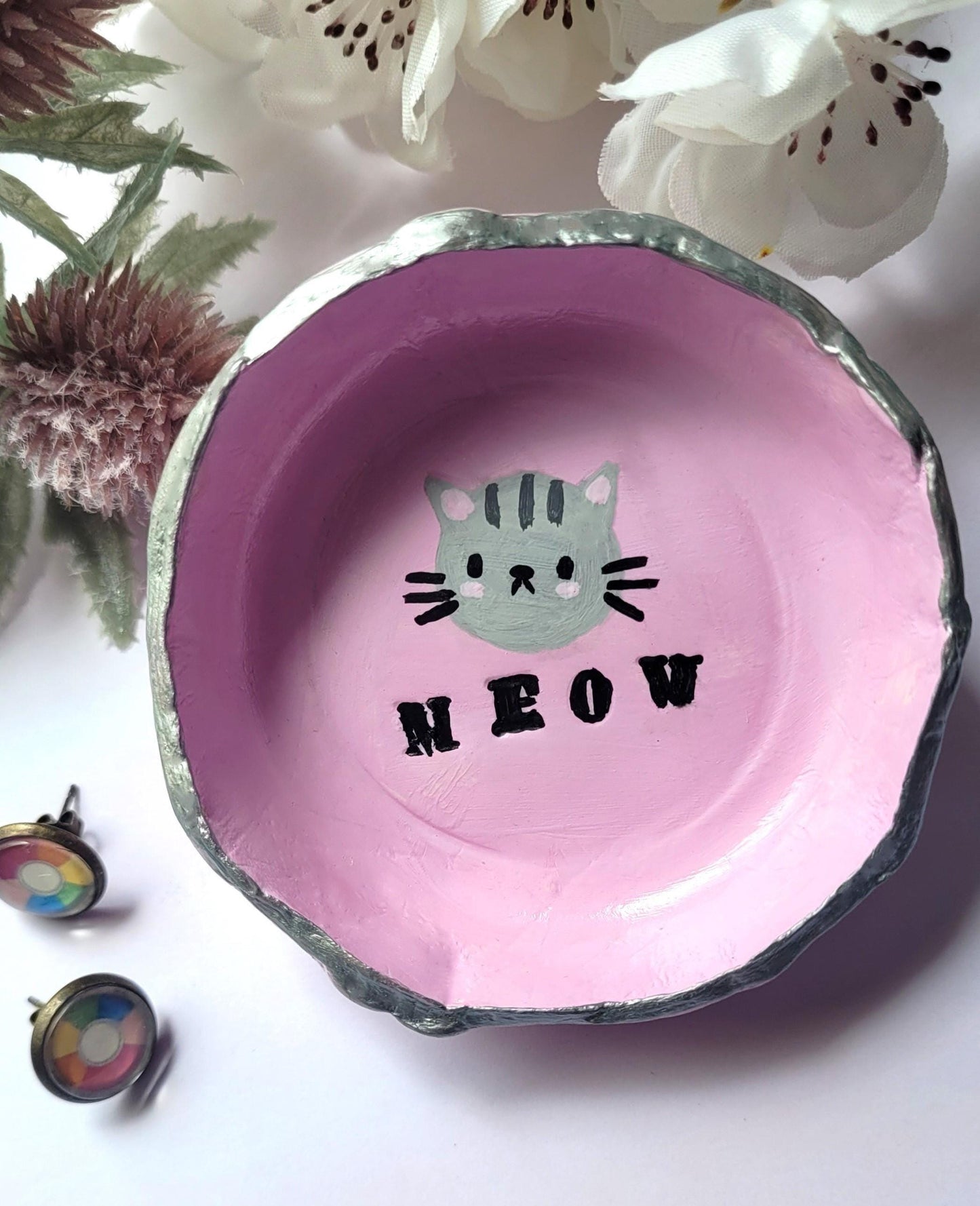 Pink cat trinket dish with meow text on it.